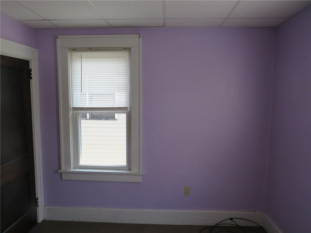 unfurnished room featuring a paneled ceiling