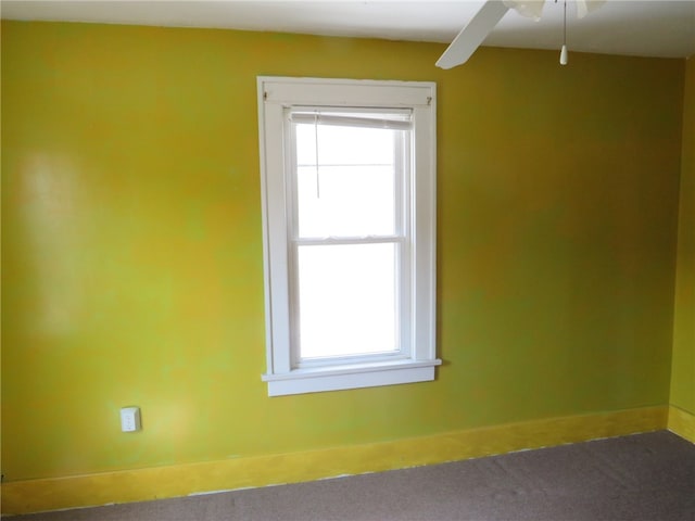 empty room with ceiling fan and carpet flooring