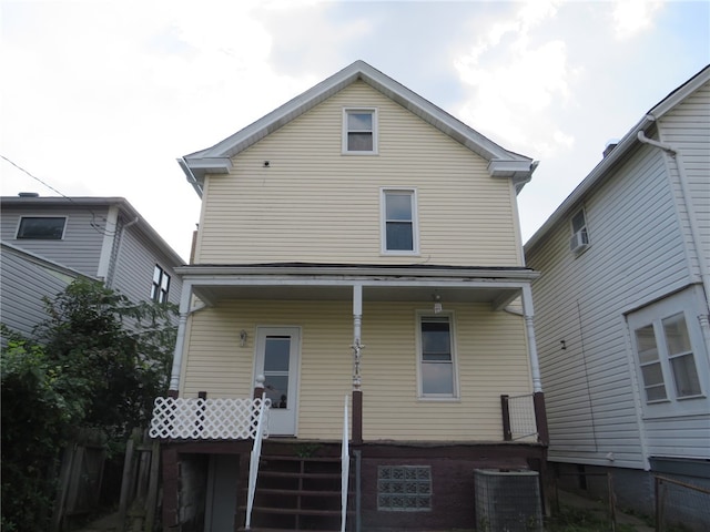 rear view of property with central AC unit