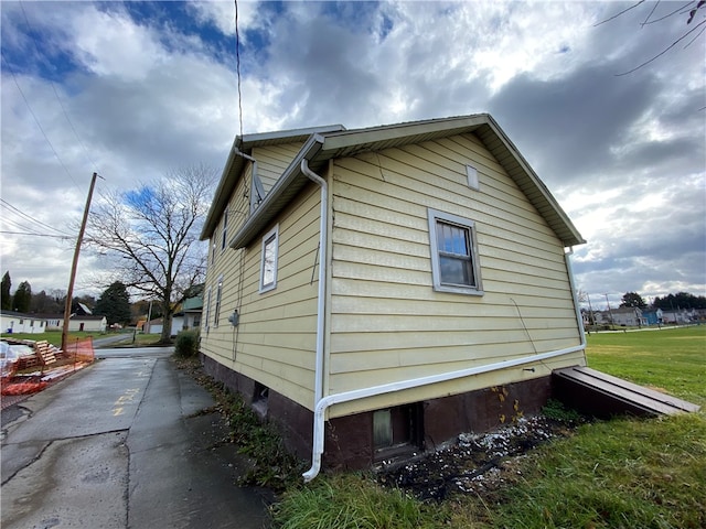 view of home's exterior with a yard