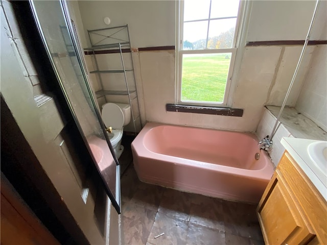 full bathroom featuring shower with separate bathtub, vanity, and toilet