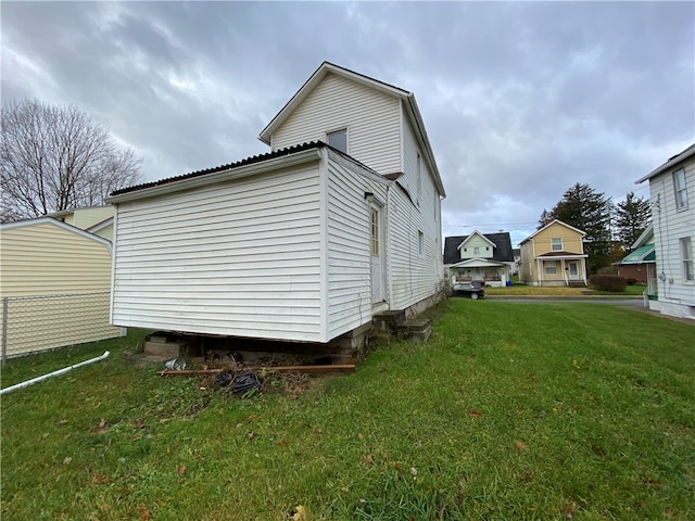 view of property exterior with a lawn