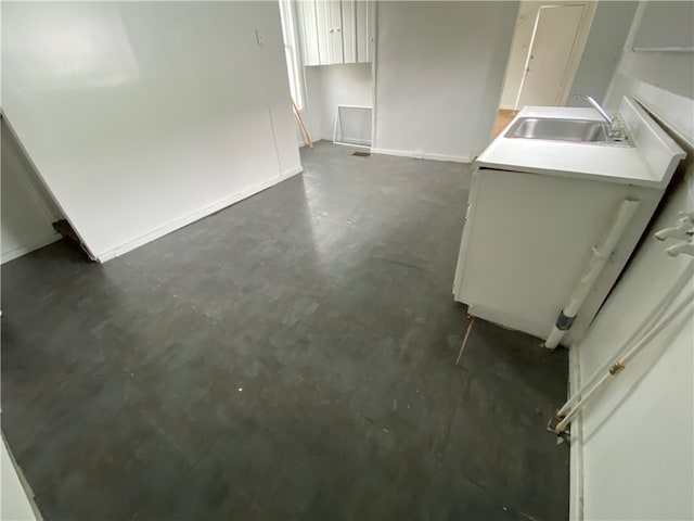 bathroom featuring sink and concrete flooring