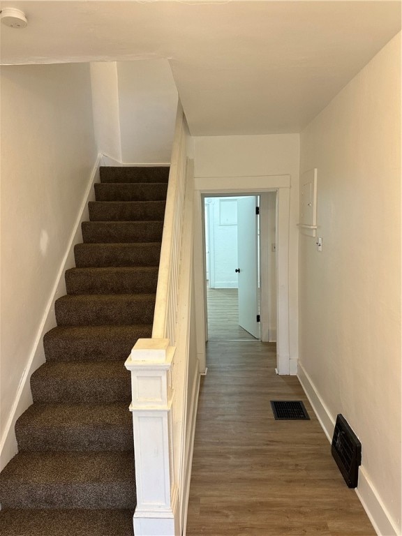 stairway featuring hardwood / wood-style flooring