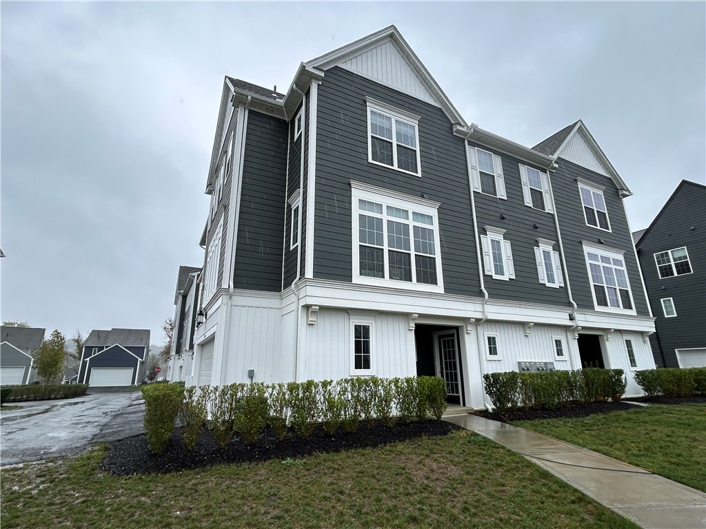 view of front of property with a front lawn and a garage