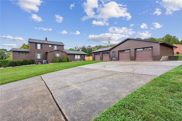 view of front of property with an outbuilding, a front yard, and a garage