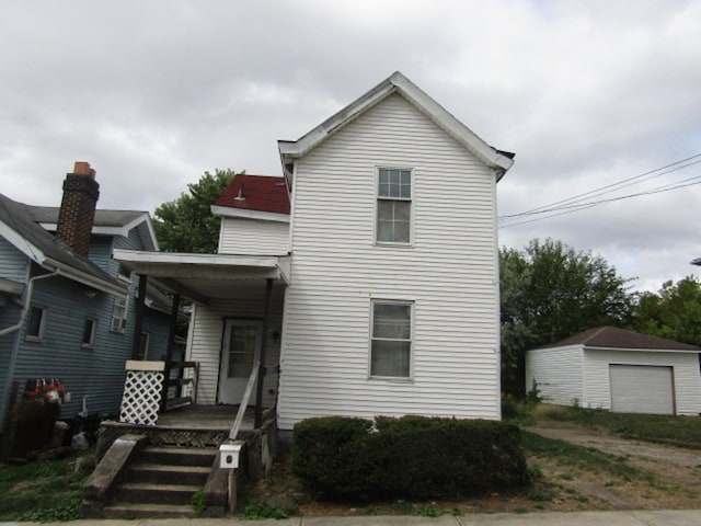 view of front facade with an outdoor structure and a garage