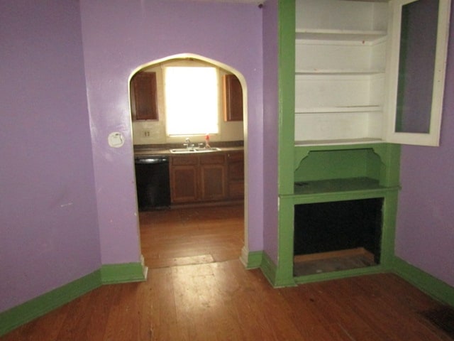 hallway featuring hardwood / wood-style floors and sink