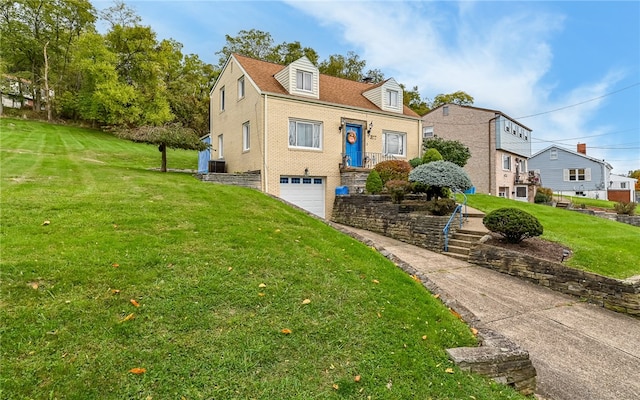 view of front of house featuring a front yard and a garage