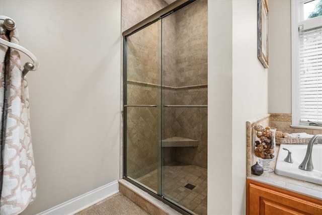 bathroom featuring sink and a shower with door