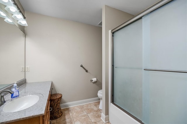 full bathroom with bath / shower combo with glass door, vanity, toilet, and tile patterned floors