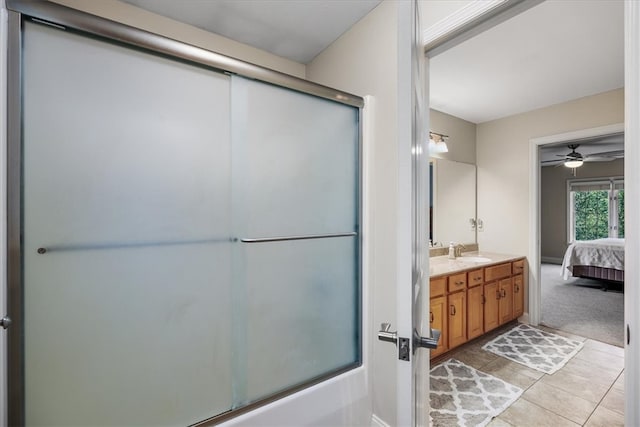 bathroom featuring tile patterned flooring, ceiling fan, vanity, and bath / shower combo with glass door