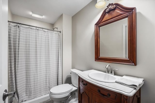 bathroom featuring vanity, toilet, and a shower with curtain