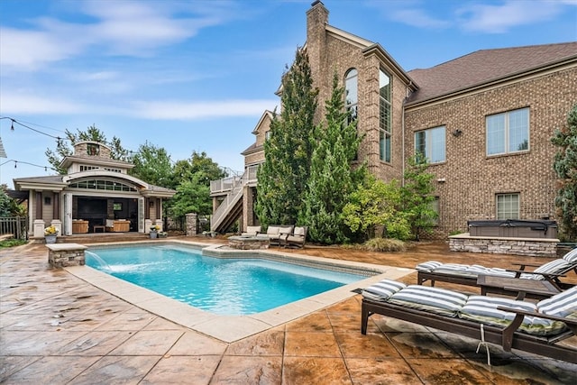 view of pool featuring pool water feature, a patio area, and a gazebo