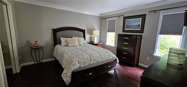 bedroom with multiple windows, crown molding, and dark hardwood / wood-style flooring