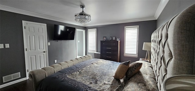 bedroom with a chandelier, hardwood / wood-style flooring, and crown molding