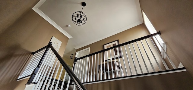 stairway with an inviting chandelier and a towering ceiling