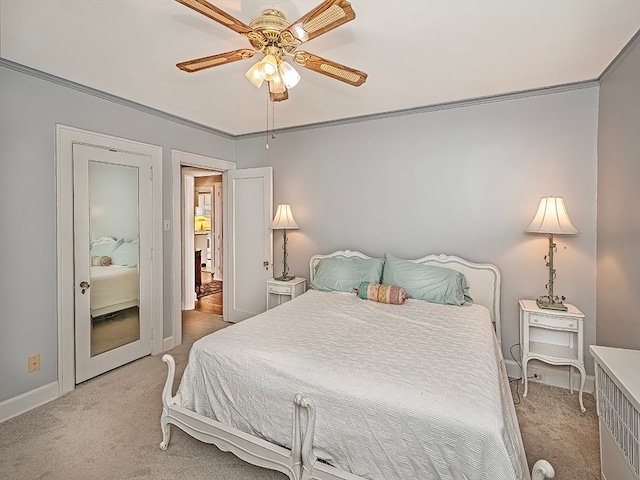 carpeted bedroom with ceiling fan and ornamental molding