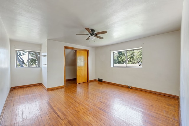 unfurnished room with ceiling fan, light hardwood / wood-style flooring, and a wealth of natural light