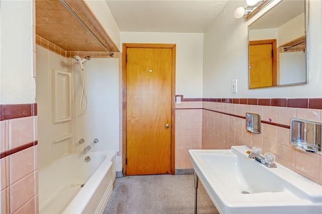 bathroom featuring shower / bathing tub combination and tile walls