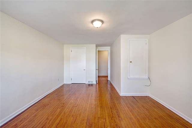 empty room with light hardwood / wood-style flooring