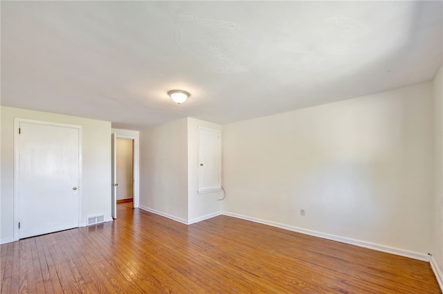 empty room featuring hardwood / wood-style flooring