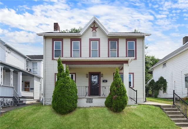 view of front of home featuring a front lawn and covered porch