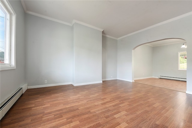 empty room with crown molding, light hardwood / wood-style floors, and a baseboard radiator