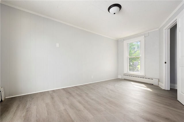 unfurnished room with hardwood / wood-style flooring, baseboard heating, and ornamental molding