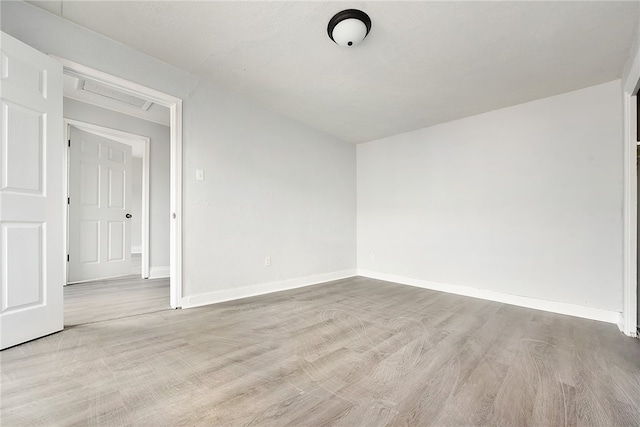 spare room with light hardwood / wood-style flooring