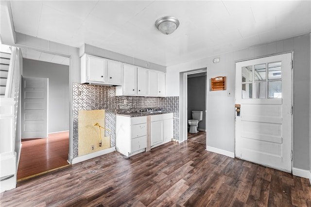 kitchen featuring decorative backsplash, dark hardwood / wood-style floors, and white cabinets