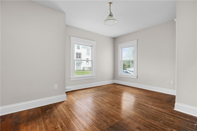 spare room featuring dark wood-type flooring