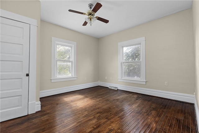 unfurnished room with ceiling fan and dark hardwood / wood-style floors