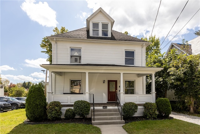 view of front of house featuring a front yard and a porch