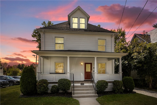 view of front of house featuring a yard and a porch