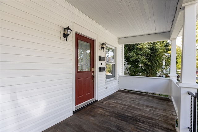 view of exterior entry featuring covered porch