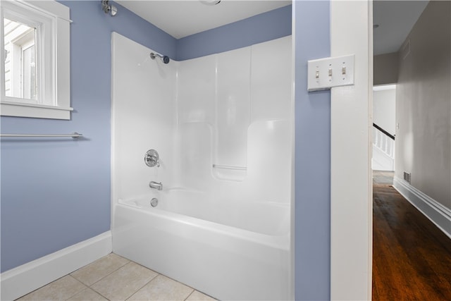 bathroom with shower / bathtub combination and hardwood / wood-style flooring