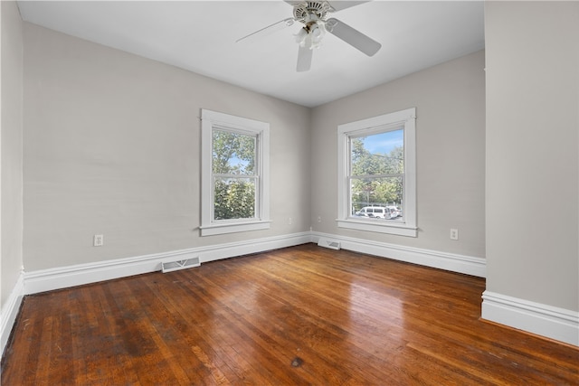 unfurnished room with ceiling fan and dark hardwood / wood-style flooring