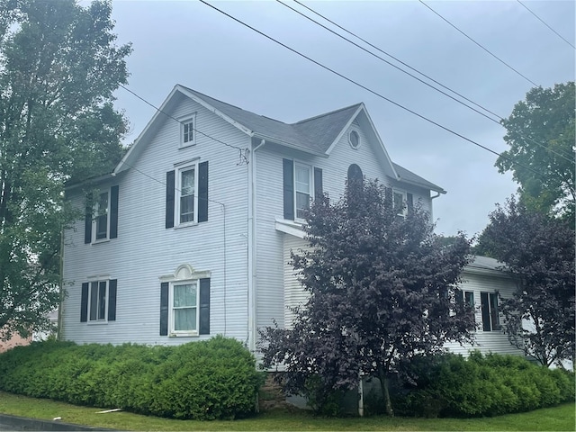 view of property exterior with a lawn