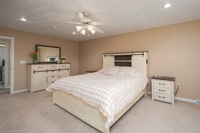 bedroom with ceiling fan and light colored carpet