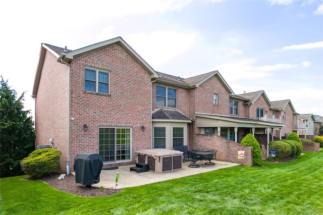 back of property with a lawn and a patio