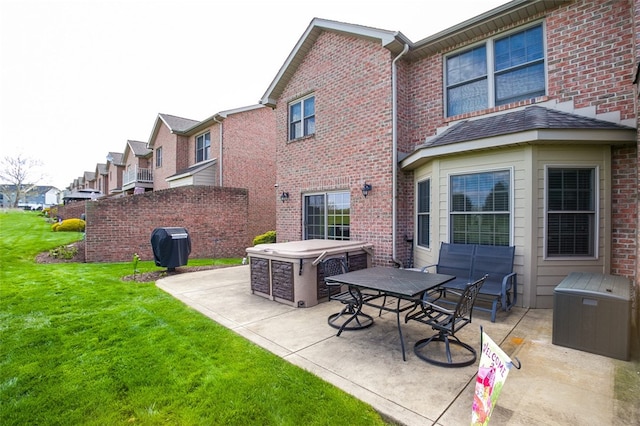 rear view of house featuring a yard and a patio area