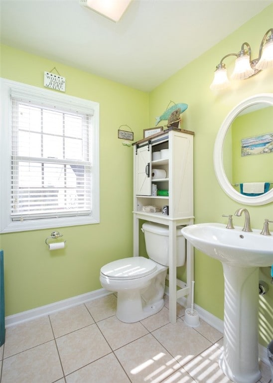 bathroom featuring toilet, sink, and tile patterned floors