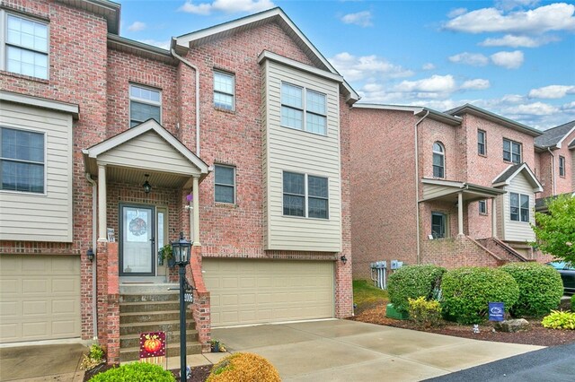 townhome / multi-family property featuring a garage