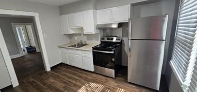 kitchen with stainless steel appliances, dark wood-type flooring, sink, and white cabinets