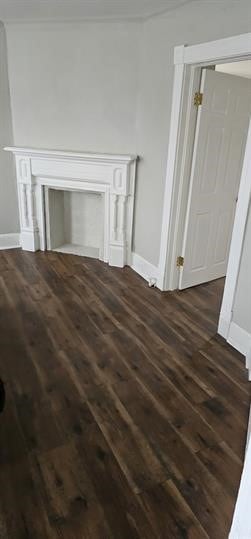 unfurnished living room featuring dark hardwood / wood-style flooring