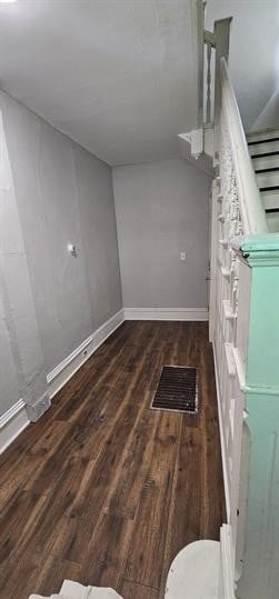 unfurnished living room with dark wood-type flooring