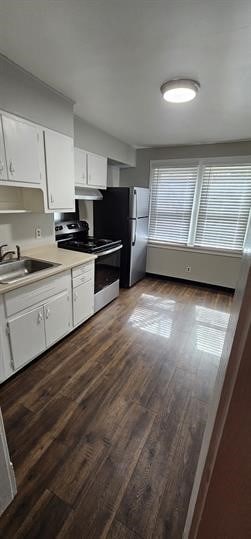 kitchen featuring white cabinetry, stainless steel appliances, dark hardwood / wood-style floors, and sink