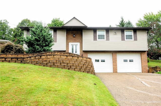 split foyer home with a front lawn and a garage