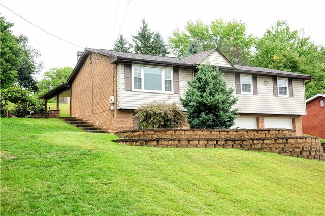 view of front of house featuring a garage and a front lawn